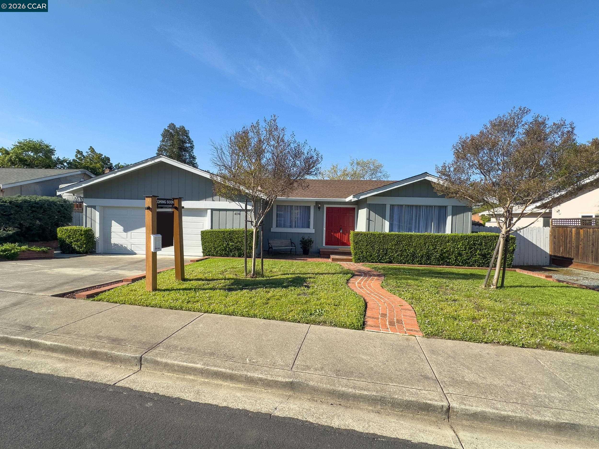 a front view of a house with a yard