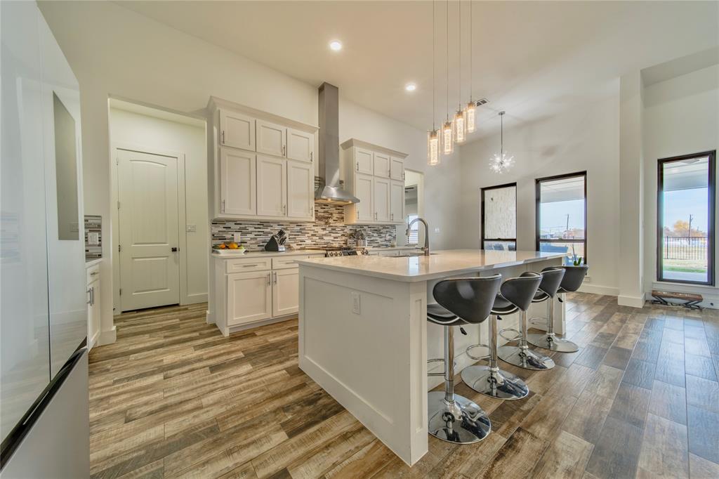 165 Ranch House Road Rockwall, TX 75032 - Photo 13 of 40 a kitchen with kitchen island a counter top space a sink stainless steel appliances and cabinets
