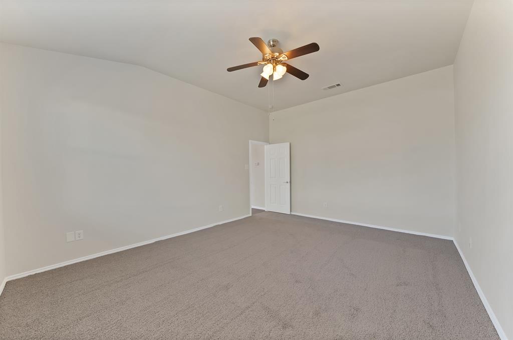 3813 Cane River Road Fort Worth, TX 76244 - Photo 15 of 28 an empty room with a ceiling fan and a window