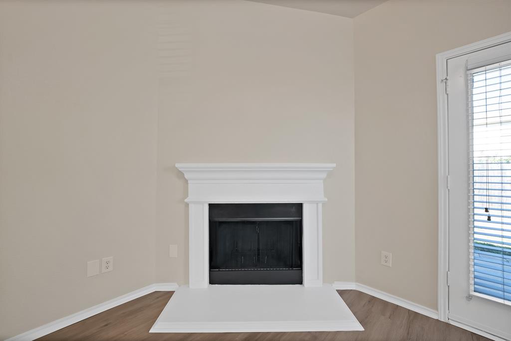 3813 Cane River Road Fort Worth, TX 76244 - Photo 20 of 28 a view of an empty room with wooden floor and a window