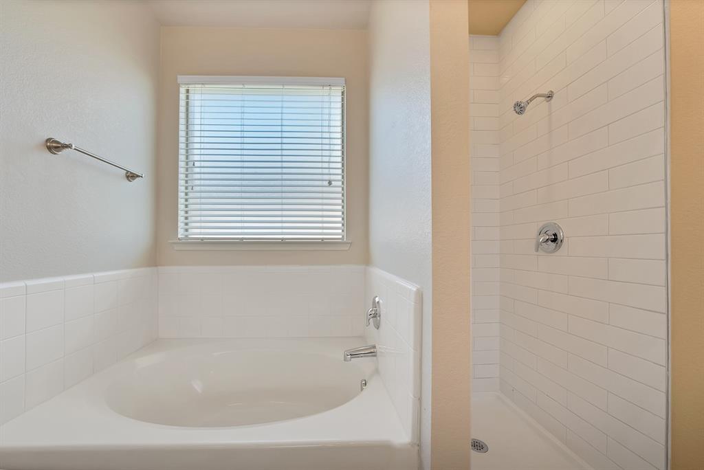 3813 Cane River Road Fort Worth, TX 76244 - Photo 21 of 28 a close up of a bathtub in a bathroom