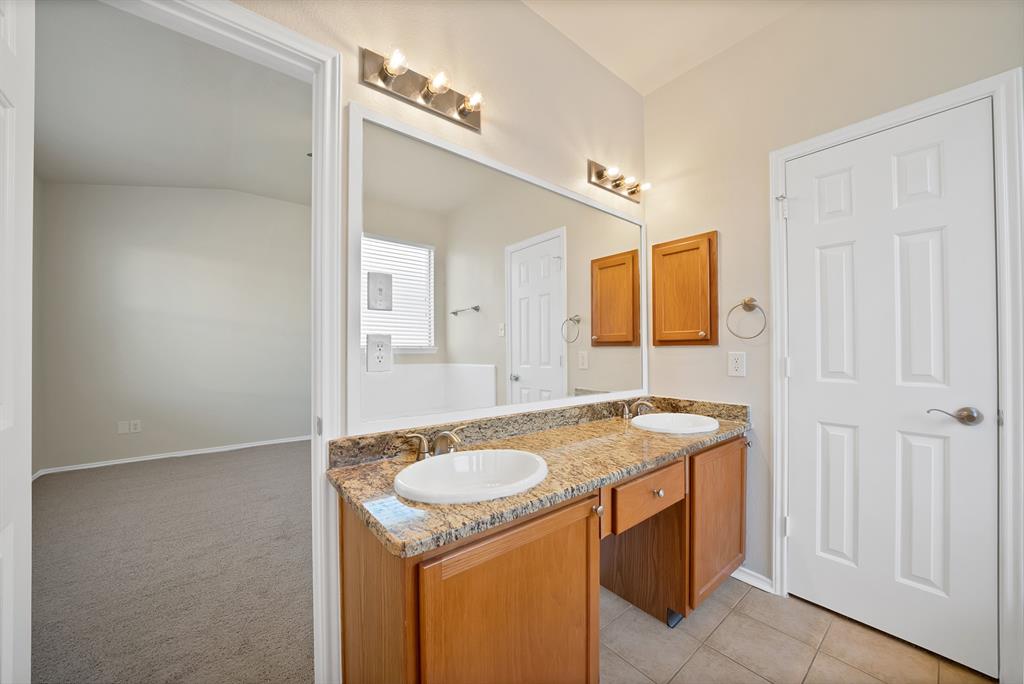 3813 Cane River Road Fort Worth, TX 76244 - Photo 22 of 28 a bathroom with a granite countertop sink and a mirror