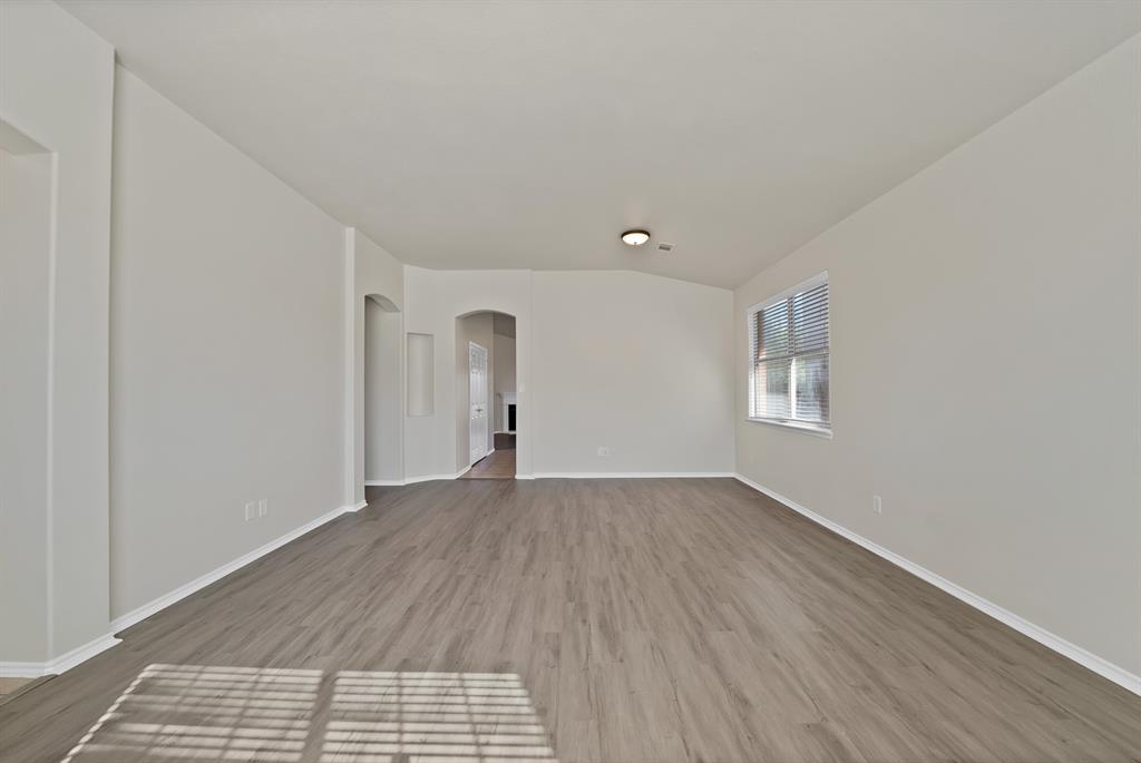 3813 Cane River Road Fort Worth, TX 76244 - Photo 6 of 28 an empty room with wooden floor and windows