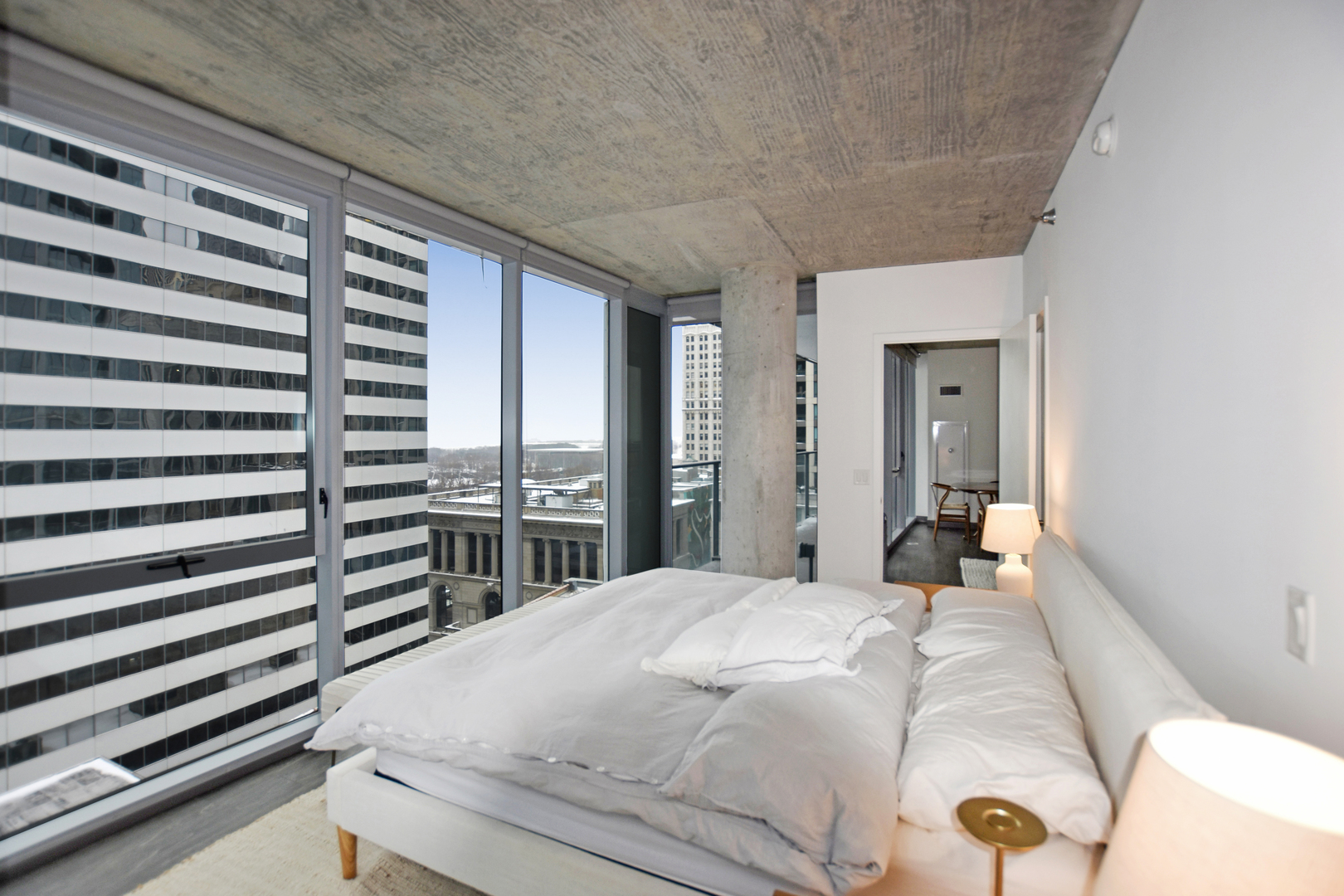 60 East Randolph Street, Unit 1303 Chicago, IL 60601 - Photo 11 of 38 a bedroom with a large bed and a chandelier