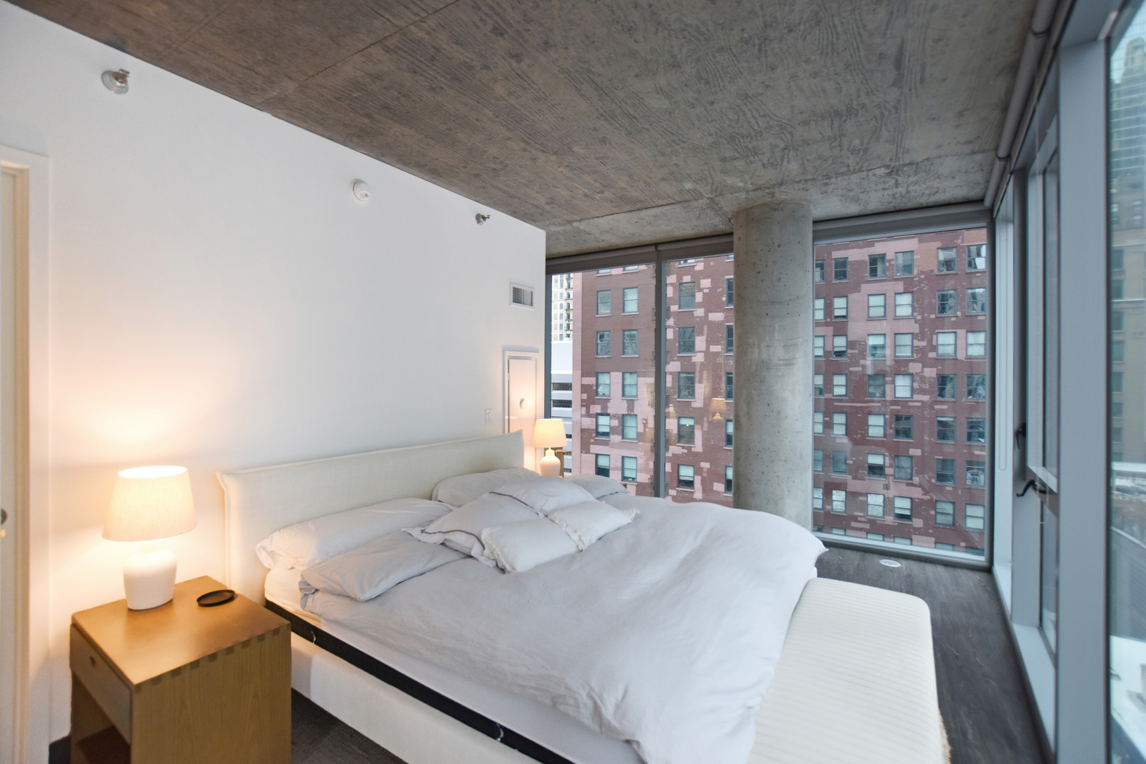 60 East Randolph Street, Unit 1303 Chicago, IL 60601 - Photo 13 of 38 a bedroom with a bed and a window
