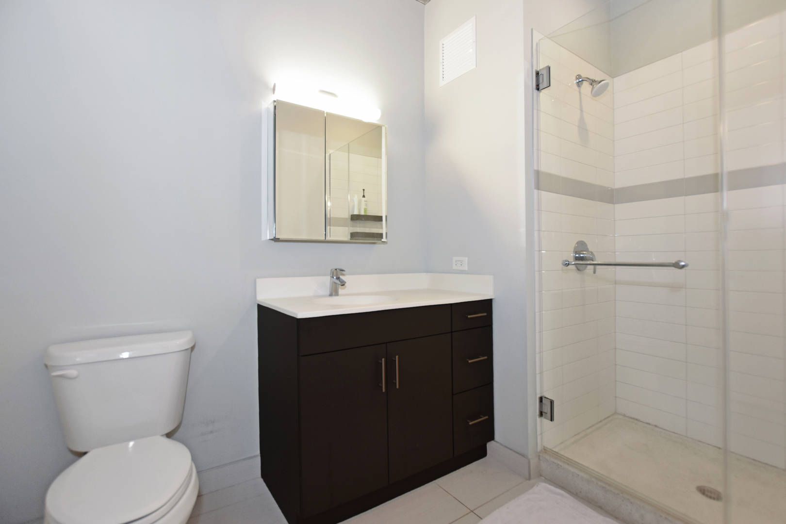 60 East Randolph Street, Unit 1303 Chicago, IL 60601 - Photo 15 of 38 a bathroom with a sink toilet and shower