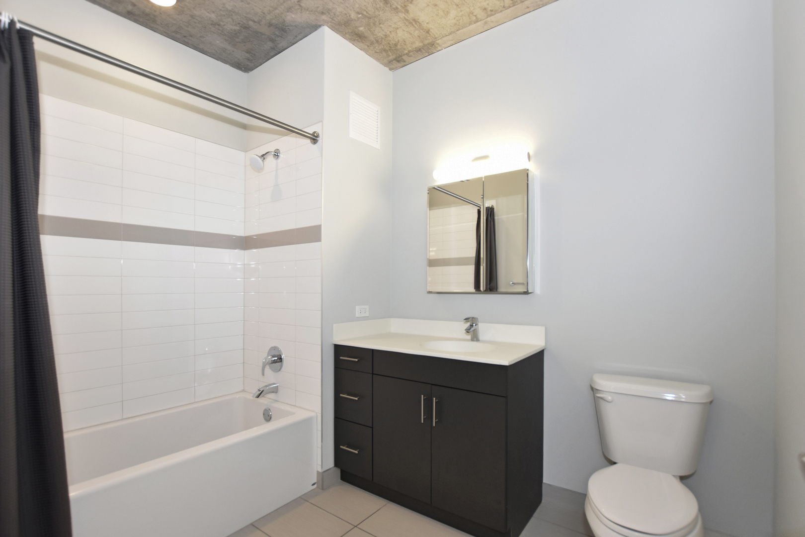 60 East Randolph Street, Unit 1303 Chicago, IL 60601 - Photo 20 of 38 a bathroom with a sink toilet and shower