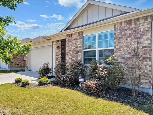 a backyard of a house with yard and outdoor seating