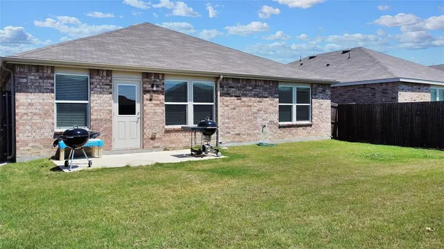 a view of a house with a yard and sitting area