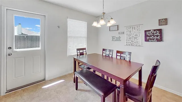 a living room with furniture lots of books and a large window