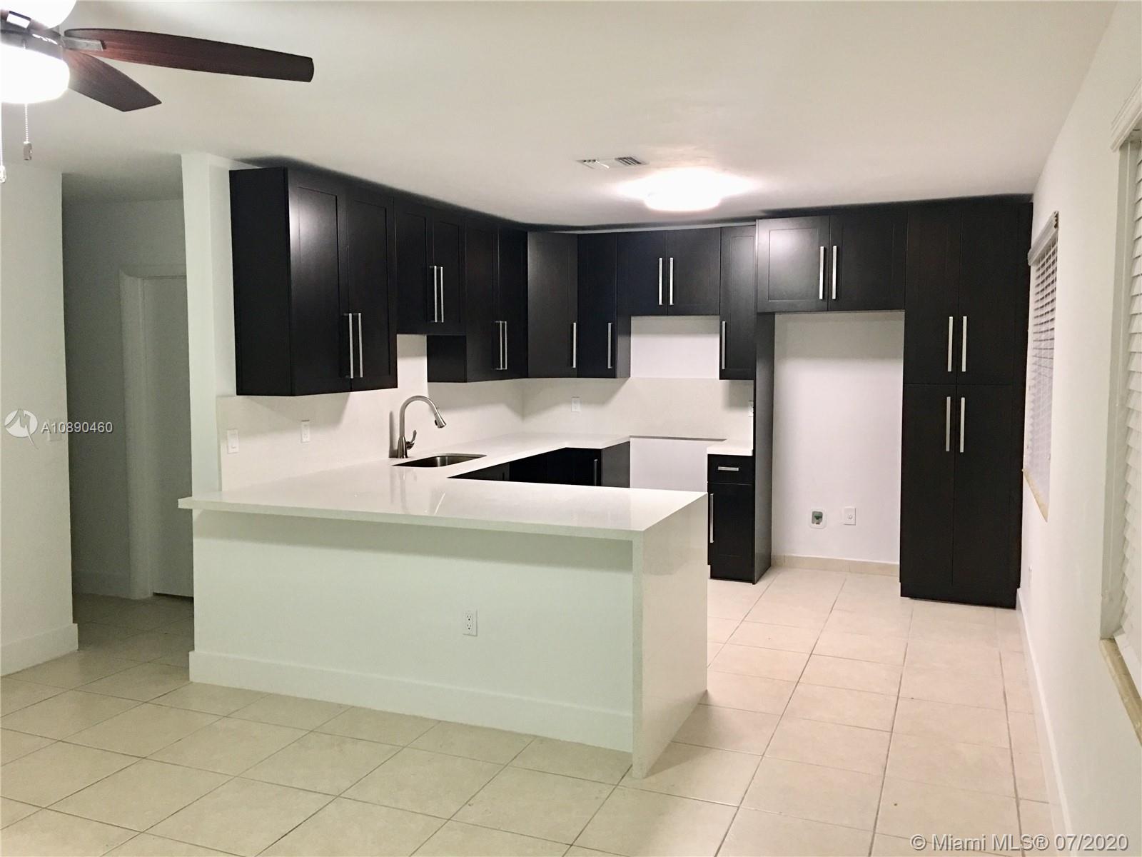 310 Southwest 34th Avenue, Unit 310 Miami, FL 33135 - Photo 1 of 18 a view of kitchen with cabinets and refrigerator
