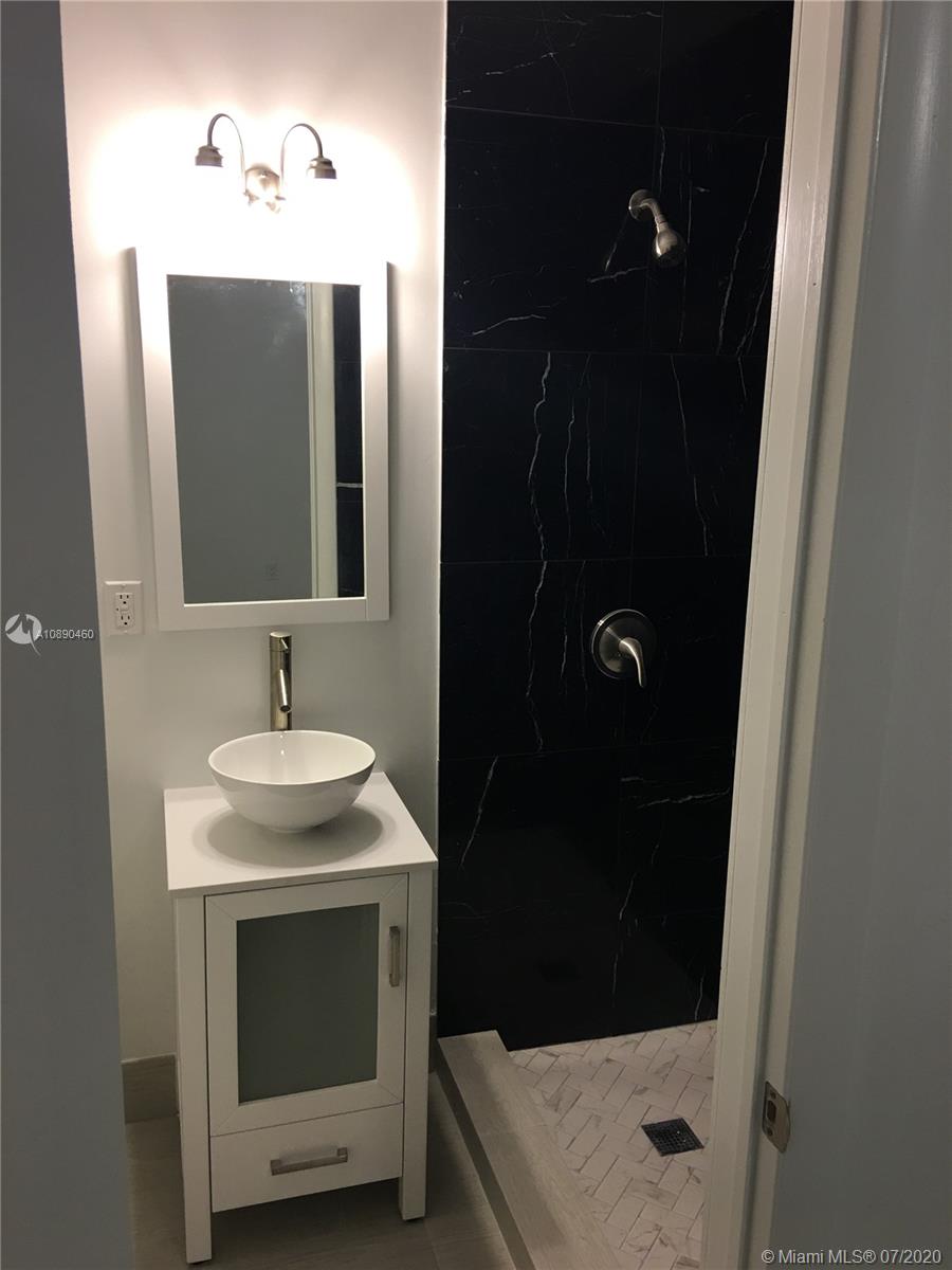 310 Southwest 34th Avenue, Unit 310 Miami, FL 33135 - Photo 14 of 18 a bathroom with a sink and mirror