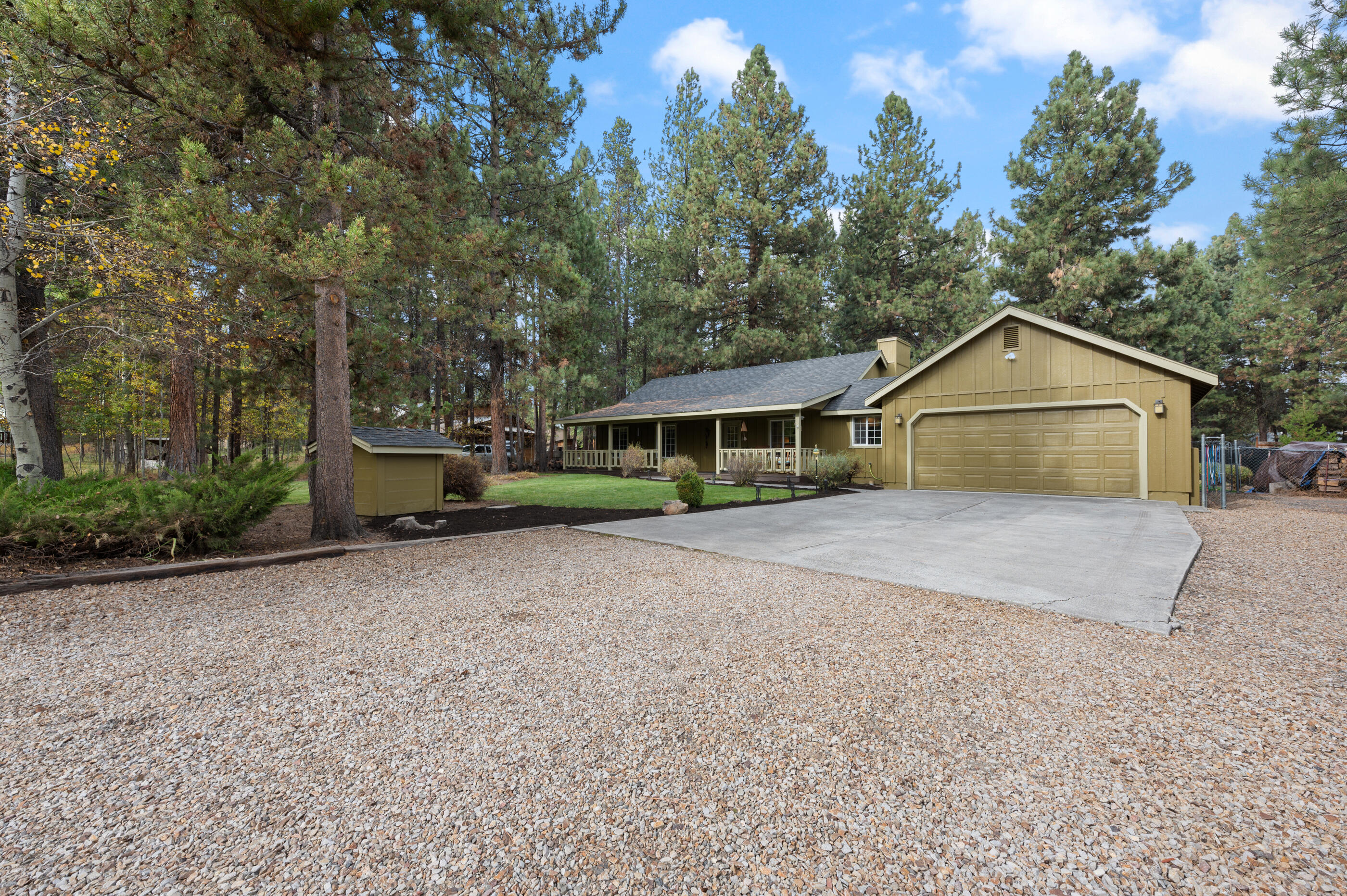 17290 Kingsburg Road Bend, OR 97707 - Photo 6 of 34 a front view of a house with a yard and garage