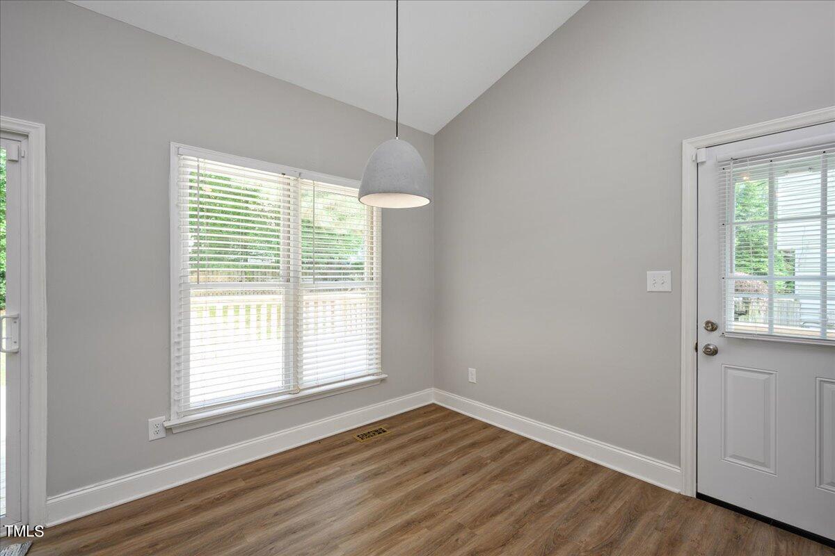 2005 Broadingham Court Raleigh, NC 27615 - Photo 11 of 27 a view of an empty room with wooden floor and a window