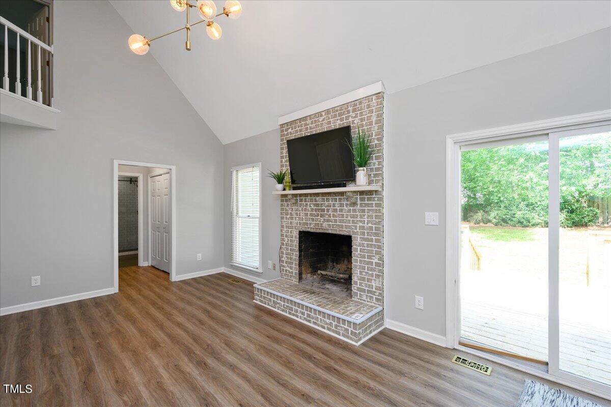 2005 Broadingham Court Raleigh, NC 27615 - Photo 12 of 27 a view of an empty room with wooden floor fireplace and a window