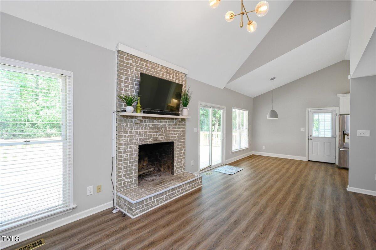 2005 Broadingham Court Raleigh, NC 27615 - Photo 15 of 27 a view of an empty room with wooden floor fireplace and a window