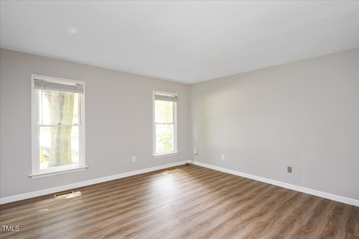 2005 Broadingham Court Raleigh, NC 27615 - Photo 16 of 27 an empty room with wooden floor and windows
