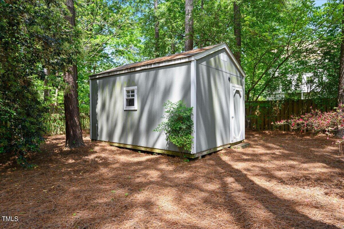 2005 Broadingham Court Raleigh, NC 27615 - Photo 24 of 27 a view of backyard with small cabin and wooden fence