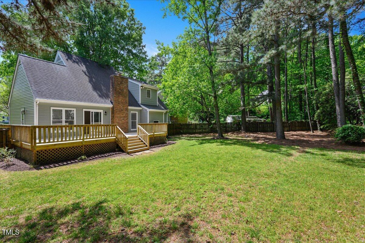 2005 Broadingham Court Raleigh, NC 27615 - Photo 25 of 27 a view of a house with a yard and a large tree
