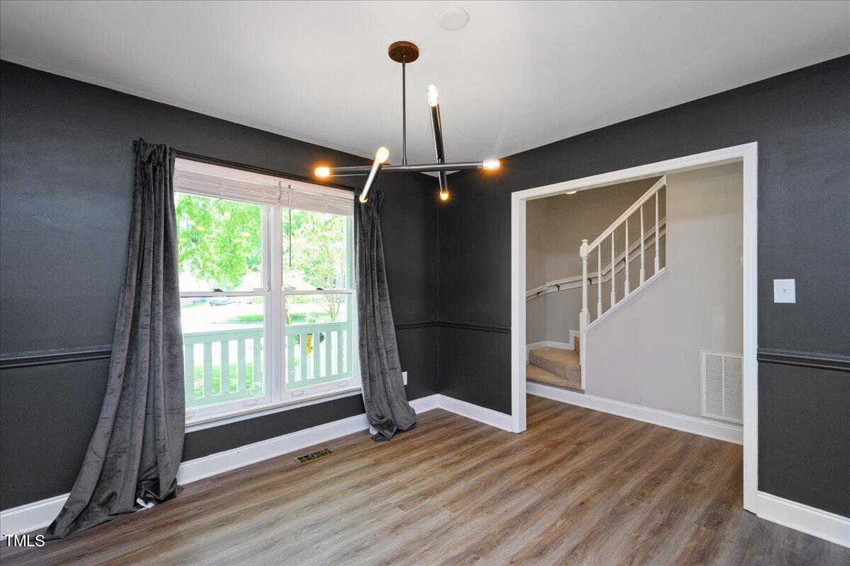 2005 Broadingham Court Raleigh, NC 27615 - Photo 6 of 27 a view of empty room with wooden floor and fan