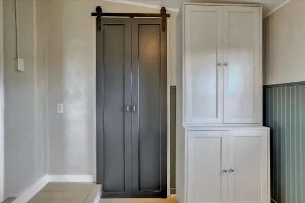 a view of kitchen with stainless steel appliances granite countertop cabinets and window
