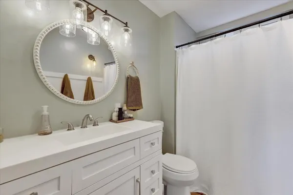 a view of a backyard with table and chairs potted plants and a palm tree