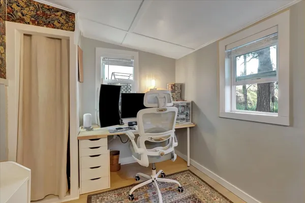 a sitting area with wooden fence and a bench