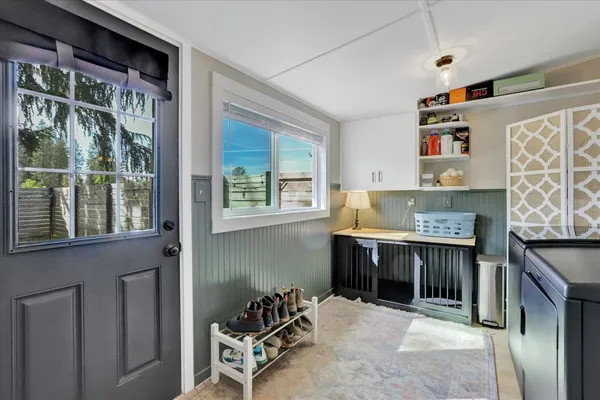 a view of a backyard with couches plants and large tree