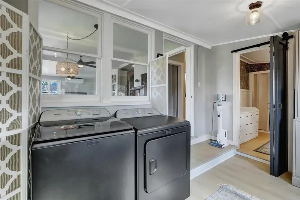 a view of a backyard with table and chairs with wooden fence and plants
