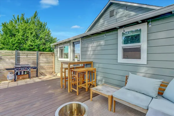 a view of a house with a big yard and large trees