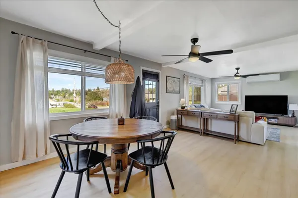 a dining room with furniture and window