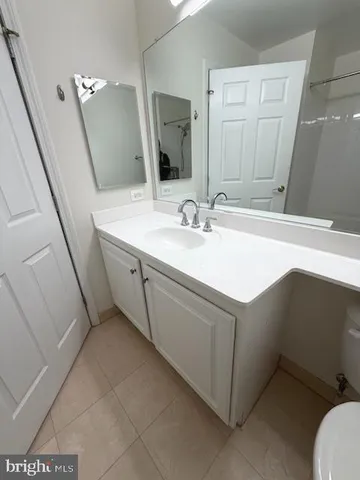 a bathroom with a sink vanity and a mirror