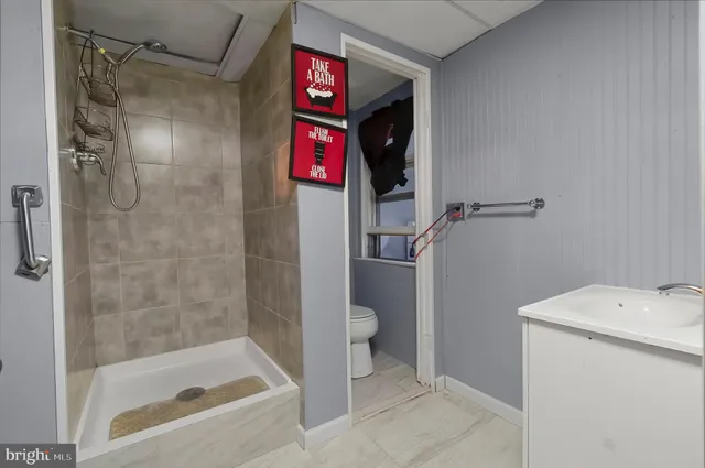 a bathroom with a shower and a toilet