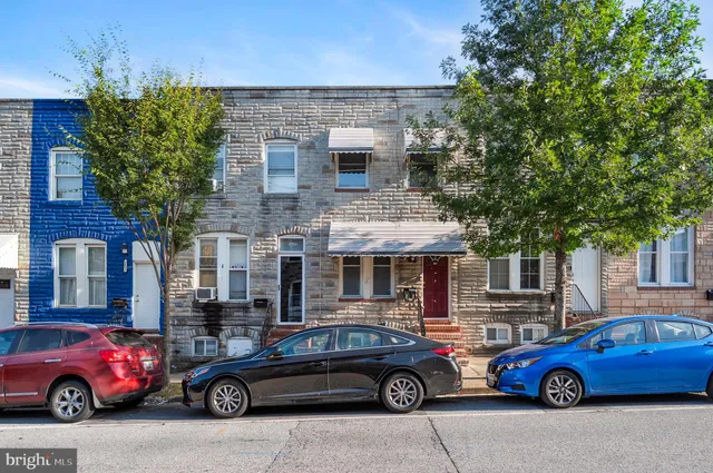 a front view of a house with parking space