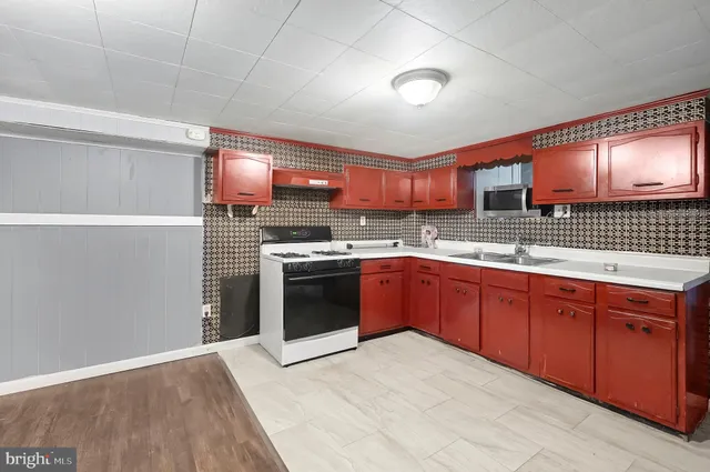 a kitchen with stainless steel appliances granite countertop a stove a sink dishwasher and a refrigerator