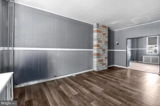 a view of an empty room with a kitchen