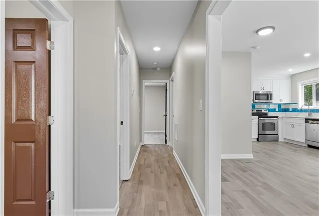 a view of a kitchen with wooden floor