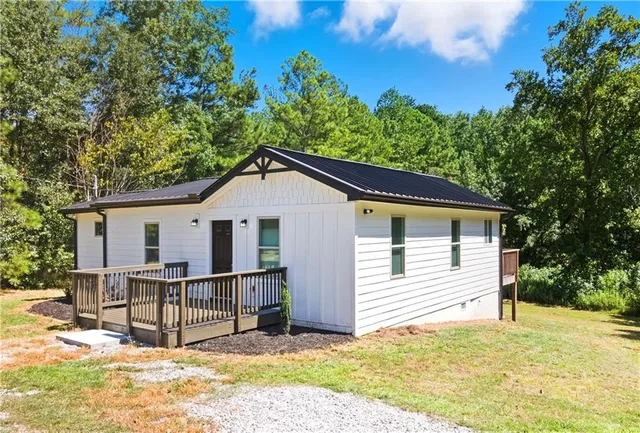 a view of a house with a yard and fence