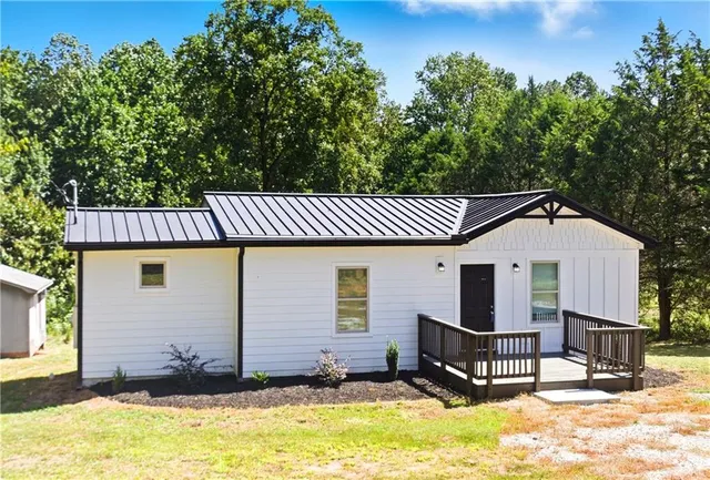 a view of a house with a patio and a yard