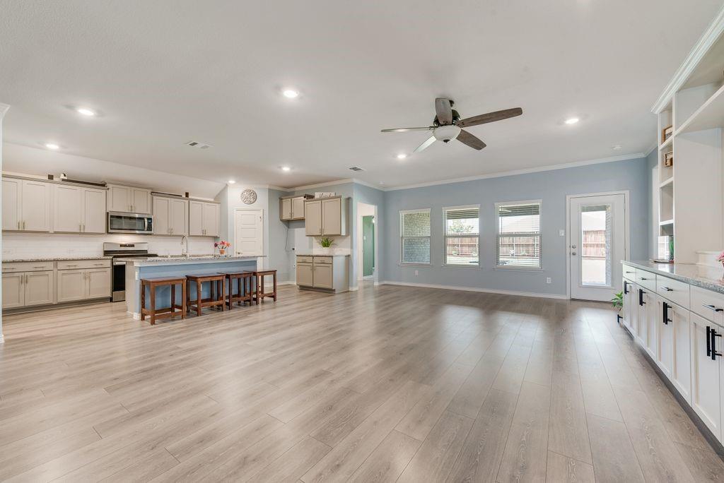 628 Bunker Hl Road Fate, TX 75189 - Photo 7 of 38 Living Room and Kitchen views. Extras throughout this thoughtfully upgraded home. Built-ins you won't find in this foorplan have been included.