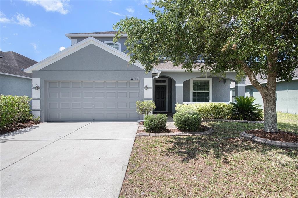 11402 Weston Course Loop Riverview, FL 33579 - Photo 1 of 1 a front view of a house with a garden