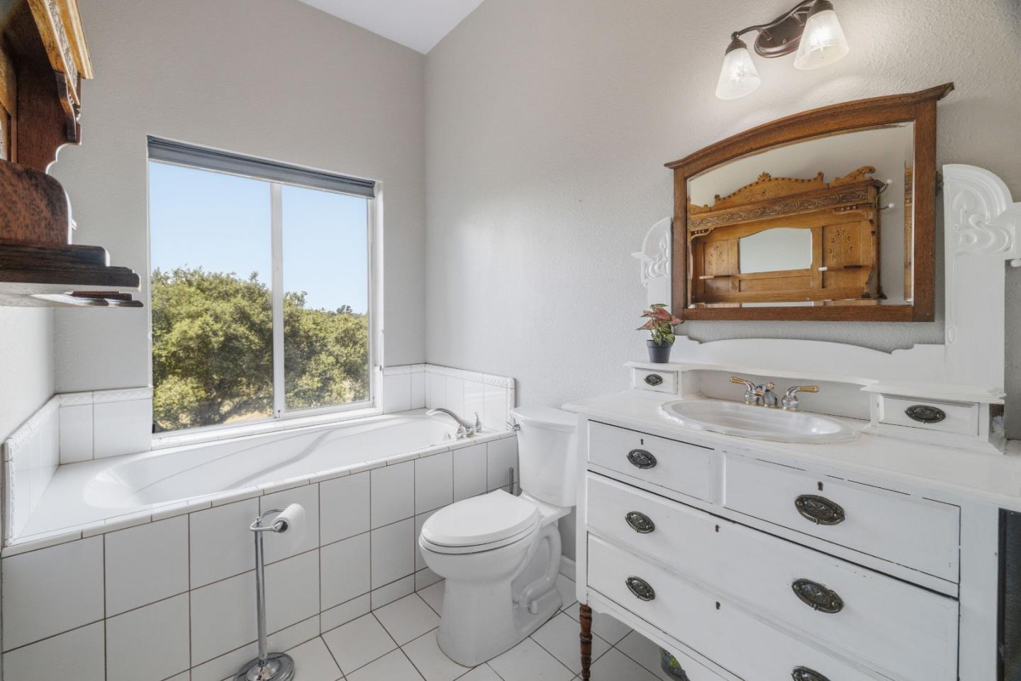 19269 Mallory Canyon Road, Unit D Salinas, CA 93907 - Photo 17 of 77 a bathroom with a toilet a sink a mirror and a window