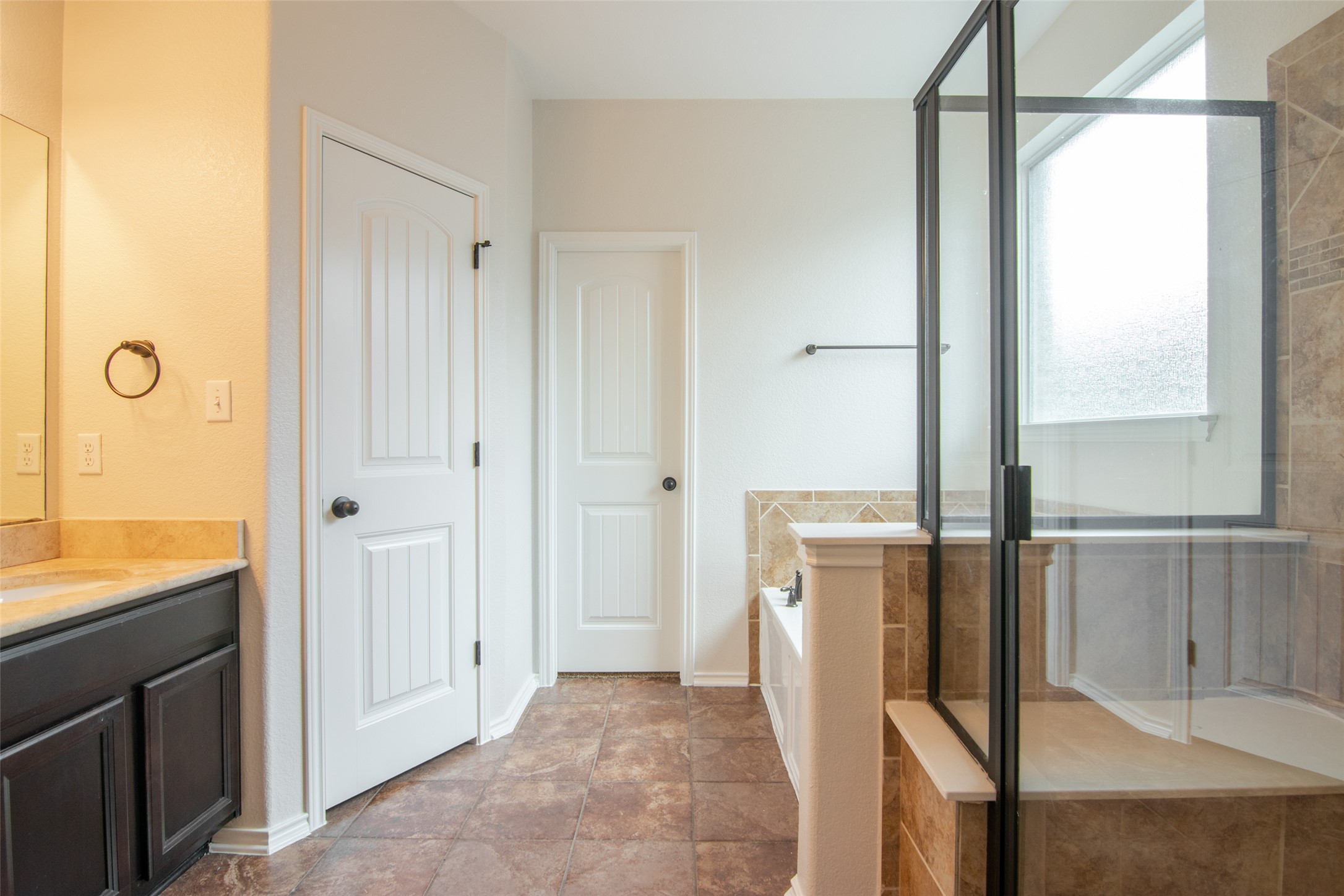 12104 Broten Street Austin, TX 78748 - Photo 17 of 32 Indulge in a primary bathroom featuring a spacious walk-in shower and a dedicated soaking tub.