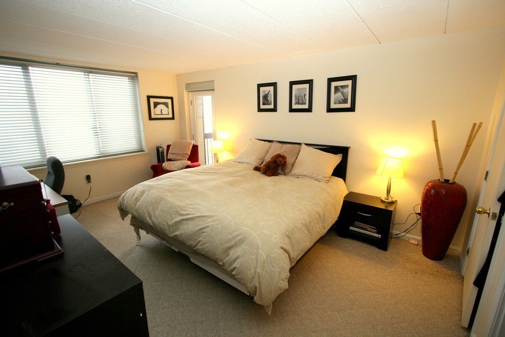 85 Brainerd Road, Unit 510 Boston, MA 02134 - Photo 7 of 25 a bedroom with a bed chair and window