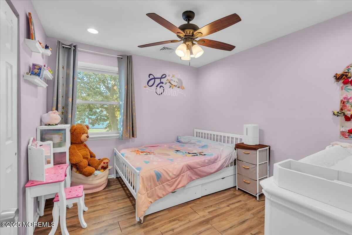 6 Reno Court Barnegat, NJ 08005 - Photo 18 of 35 a bedroom with a bed and a chandelier