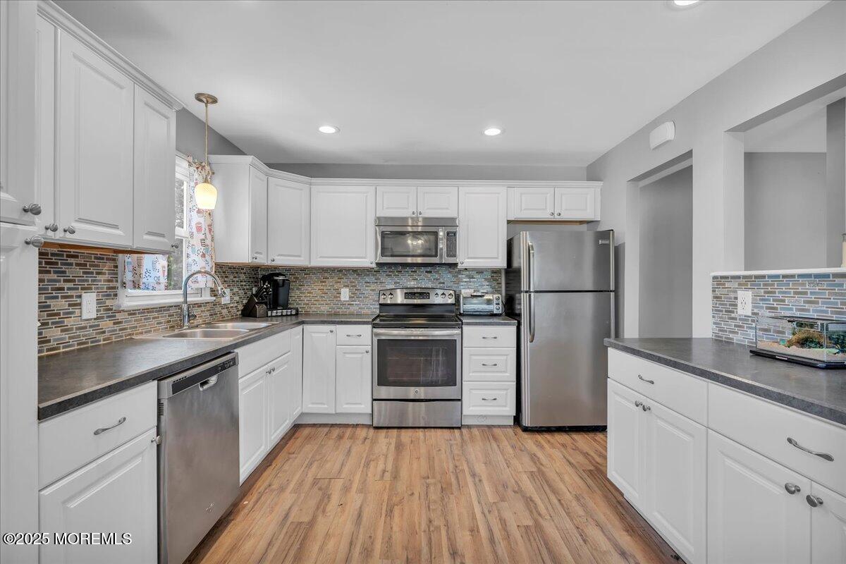 6 Reno Court Barnegat, NJ 08005 - Photo 9 of 35 a kitchen with a refrigerator and a stove top oven