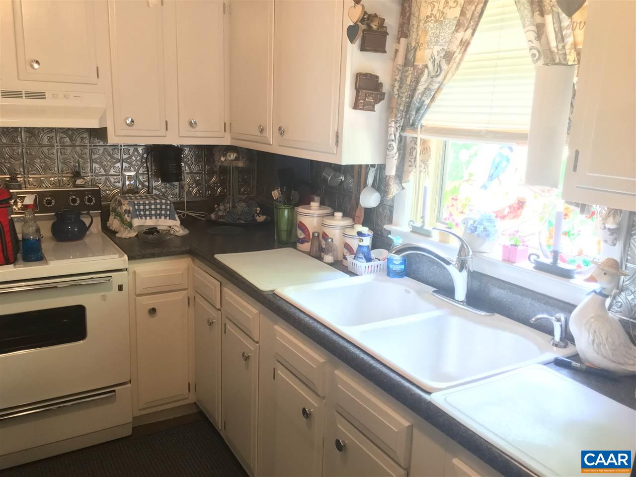 1715 Oneals Road Madison, VA 22727 - Photo 7 of 11 a kitchen with granite countertop white cabinets and white appliances