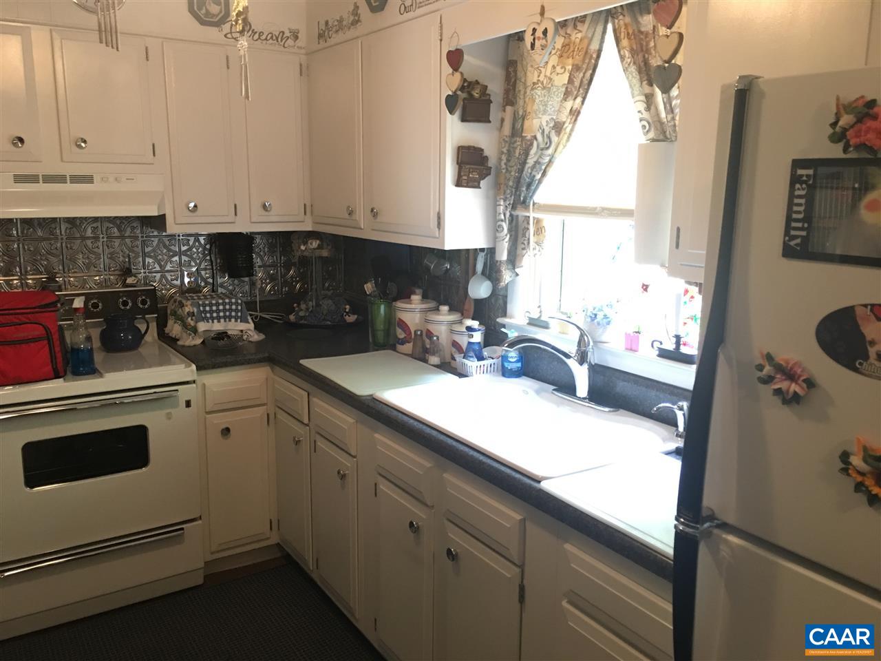 1715 Oneals Road Madison, VA 22727 - Photo 8 of 11 a kitchen with granite countertop white cabinets and white appliances