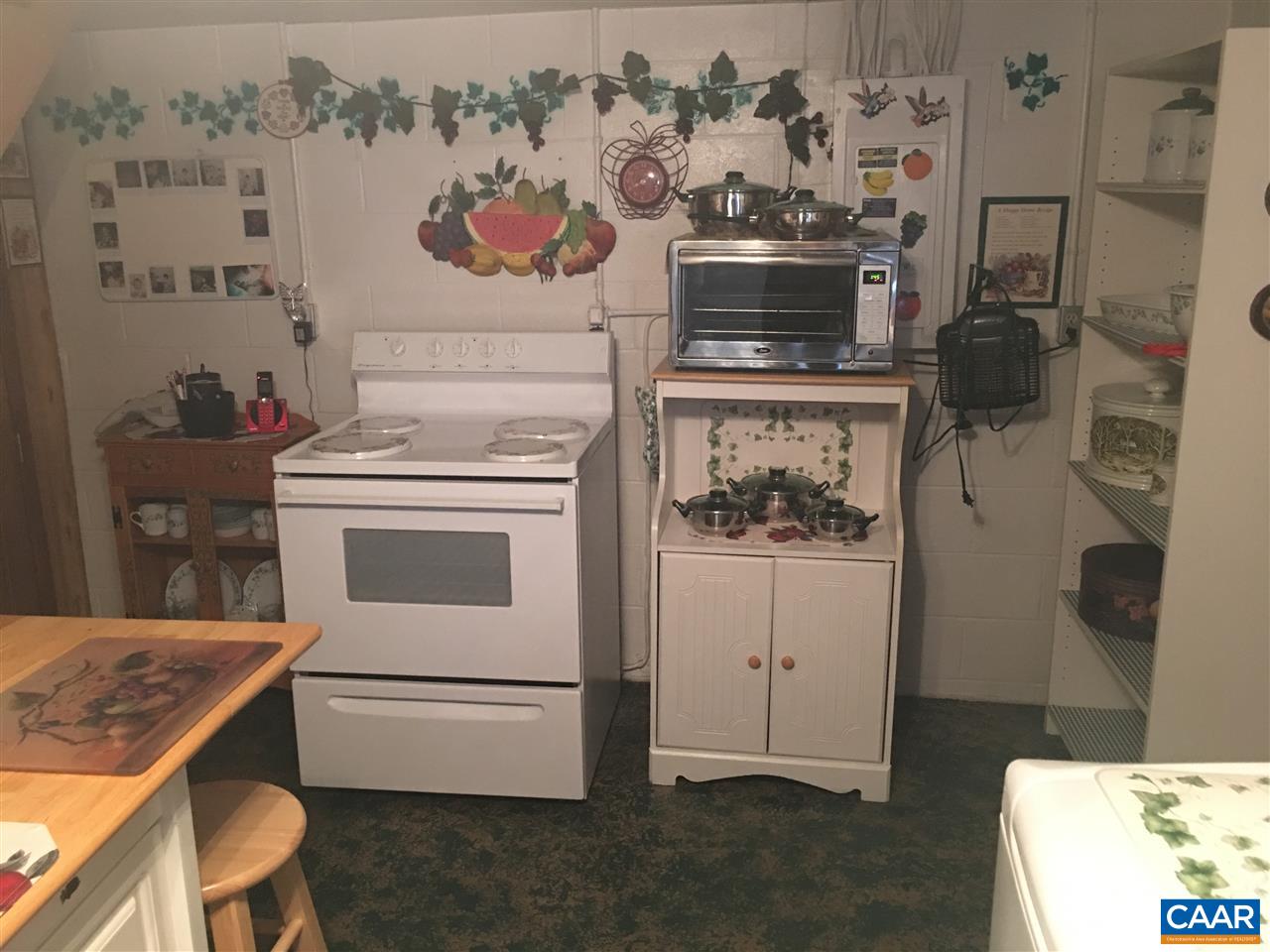 1715 Oneals Road Madison, VA 22727 - Photo 9 of 11 a white stove top oven sitting inside of a kitchen
