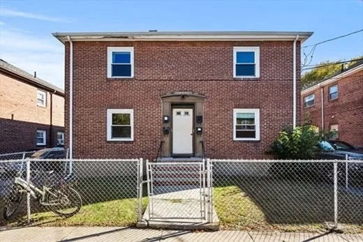 a front view of a house with a fence